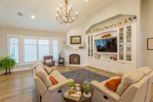 Large bright living room with a fireplace and mounted tv